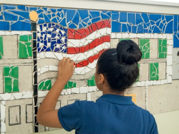 Ashley working on Tacony Academy Charter High School mural